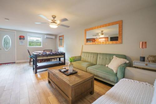a living room with a green couch and a table at Whispering Pines in West Palm Beach