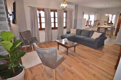 a living room with a couch and a table at Apozari Xenias Apt in Kastoria