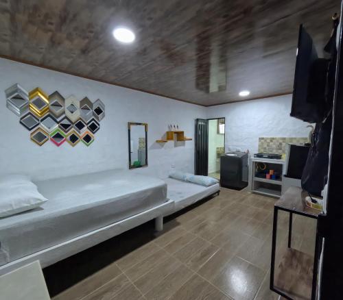 a bedroom with a large bed in a room at Hospedaje Luz d' Luna in Puerto Triunfo