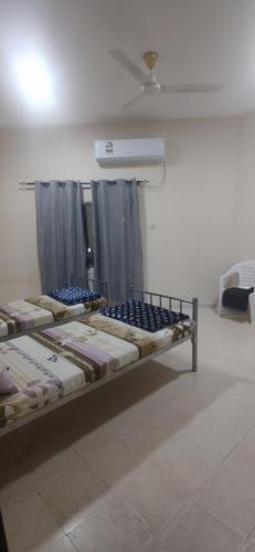 Postel nebo postele na pokoji v ubytování Muscat Galaxy Hostel