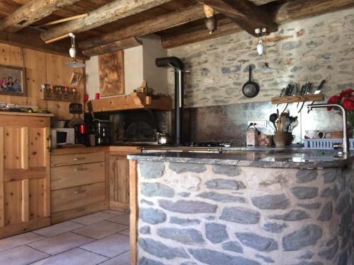 a kitchen with a stone counter top in a room at Chalet Saint-Roch in Termignon
