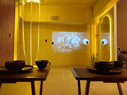 two tables with bowls on them in a room at Amber Apartment at Downtown in Chihuahua