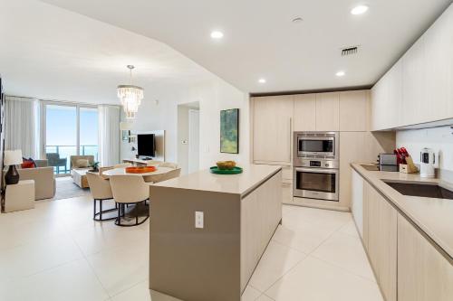 an open kitchen and living room with a table and chairs at Lyfe Residence Building - Private apts over the beach in Hollywood