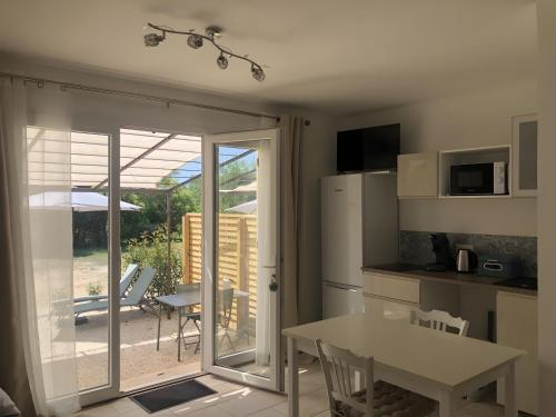 a kitchen with a door open to a patio at La Cigale Et La Fourmi in Les Taillades