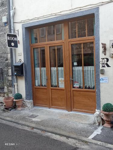 a wooden door on the side of a building at Room - Les loups bleus in La Burbanche