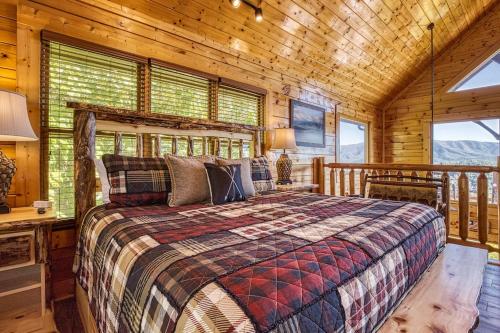 a bedroom with a bed in a wooden cabin at VIEWS! - Hot Tub - 3 Decks - Community Pool in Park Settlement