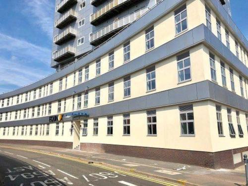 a large white building on a city street at The Velvet Nest 2BR 2BA in Leicester