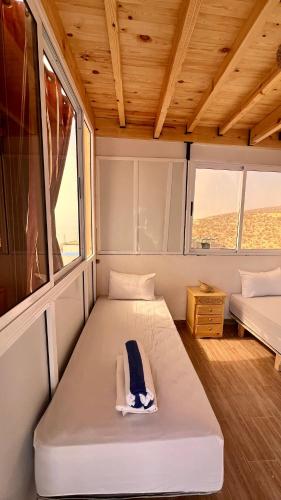 a small room with two beds in the middle at Tourma House in Taghazout