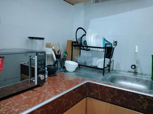 a kitchen with a sink and a counter top at Cutie Coastal Studio in Mombasa