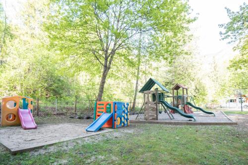 a playground with a slide and a play set at Revelstoke RV & Cabin Resort in Revelstoke