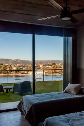 a bedroom with a large window with a view at LUNALBA in Potrero de Garay