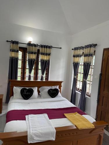a bedroom with a bed with two pillows on it at Wayanad Midnight Oasis in Meenangadi