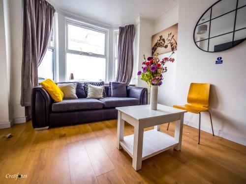a living room with a couch and a table at En-suite 1 Woodhouse, private bath, 2 kitchen in Stoke on Trent