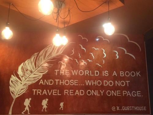a sign on a wall with lights on it at K Guesthouse Adults only in Krabi town