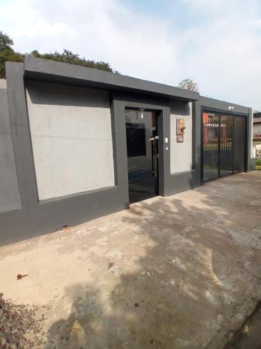 a building with a garage with a door and a building at A home away from home in Ijuí