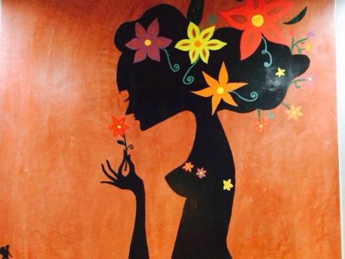 a painting of a tree with flowers on a wall at K Guesthouse Adults only in Krabi town
