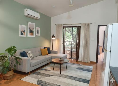 a living room with a couch and a table at Navilehomestay in Candolim