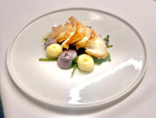 a white plate of food on a table at Locanda Marco in Bellinzona