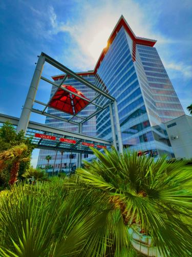 a tall building with palm trees in front of it at Scarlet Pearl Casino Resort in Biloxi