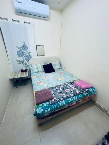 a small bedroom with a bed in a room at Budget Hostel Rooms in Al Ain