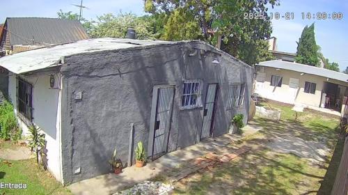 a small house with its door open in a yard at hospedaje El Colibrí in La Unión
