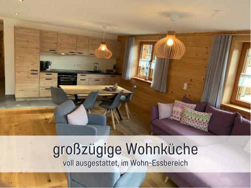 a kitchen and a living room with a table and chairs at Ferienwohnungen Scholl - private Sauna oder Infrarotkabine in Bad Hindelang
