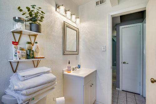 a white bathroom with a sink and a mirror at 5 Mi Circle B Bar Reserve Lakeland Getaway! in Lakeland