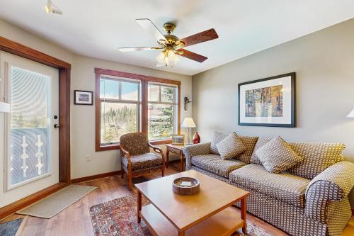 a living room with a couch and a table at Eagle Springs East 402: Buffaloberry Suite in Solitude