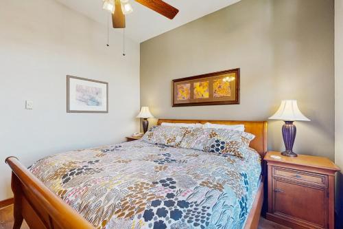 a bedroom with a bed and a table with a lamp at Eagle Springs East 402: Buffaloberry Suite in Solitude