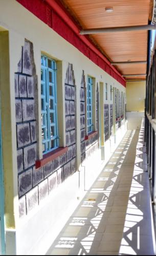 an empty hallway of a school building with blue windows at Mylon deluxe in Nakuru