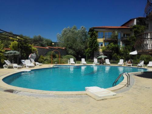 una gran piscina con sillas y un edificio en La Mer Apartment, en Rogachevo