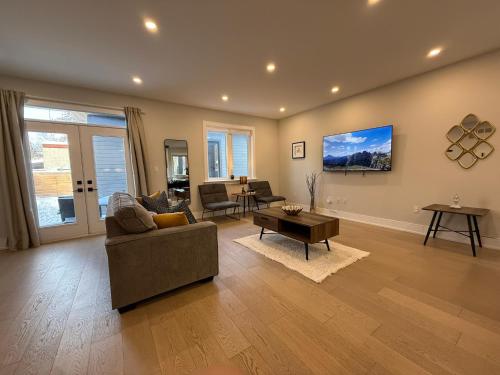 a living room with a couch and a table at Prestige 3BR Luxury Living in Queen West in Toronto