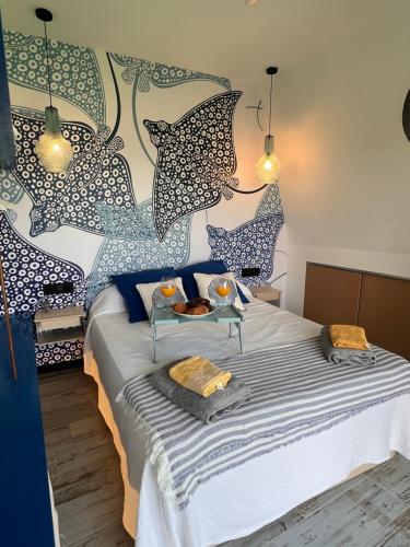 a bedroom with a bed with a table on it at Barco - casa con jardín privado frente al mar in Mareny Barraquetas