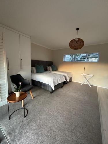 a bedroom with a bed and a chair and a window at Bella Vista Lago in Marina da Gama