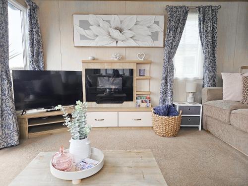 a living room with a television and a couch at Cornish Dream in Truro