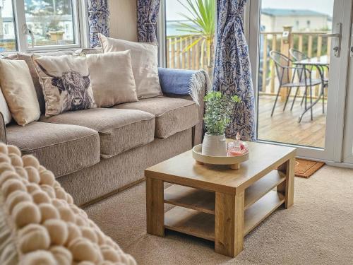 a living room with a couch and a coffee table at Cornish Dream in Truro
