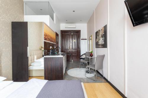 a hotel room with a bed and a desk at Apartamenty Długa 27 in Kraków