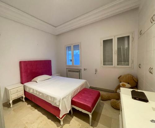 una camera da letto con un letto grande e una sedia rossa di Zen apartment a Tunisi