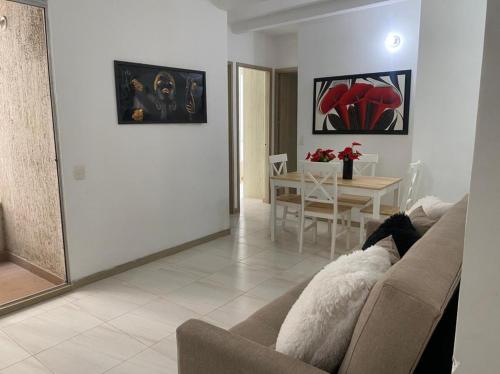 a living room with a couch and a table at Apartamento Playas de Marbella in Cartagena de Indias
