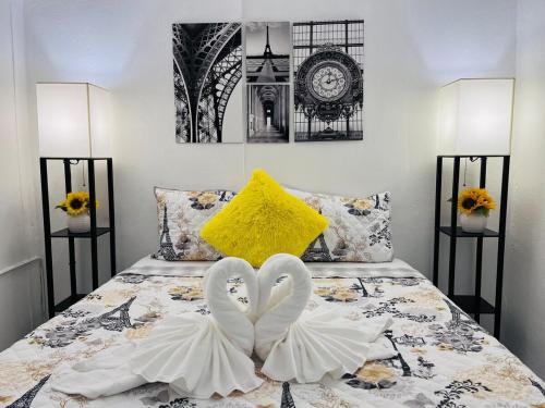 two white swans are forming a heart on a bed at Center of everything, art, beach and culture in santurce in San Juan