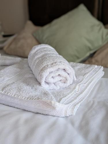 a rolled up towel on top of a bed at Rivera Raška in Raška