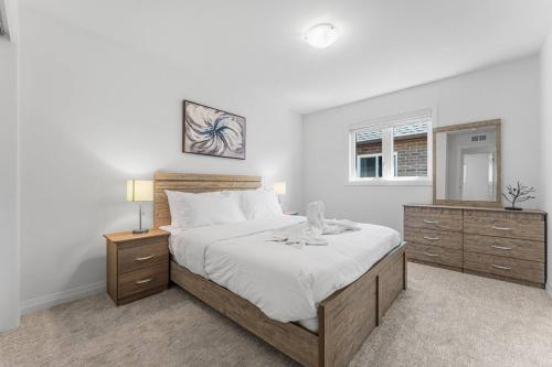 a bedroom with a large bed and two night stands at Luxury New Home By Niagara Fall in Fonthill