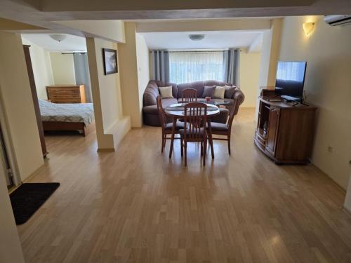 a living room with a table and chairs and a couch at Апартамент Венеция in Lovech