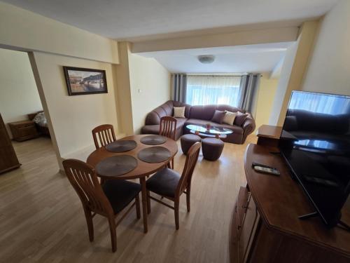 a living room with a table and a couch at Апартамент Венеция in Lovech