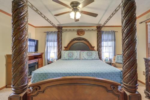 a bedroom with a four poster bed with a ceiling fan at Playground and Grill Pet-Friendly Griffin Getaway! in Griffin