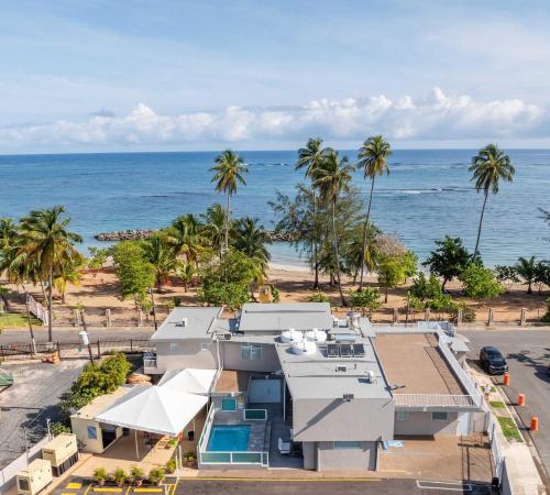 an aerial view of a house and the ocean at AQUA Terrazas Studio 5 - Oceanfront, Pool & Local Dining in Mameyal