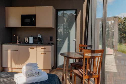 a kitchen with a table and chairs and a table at Pulli Country Club in Pärnu
