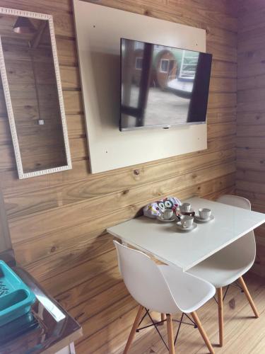 a dining room with a white table and a mirror at Floripa Glamping in Florianópolis
