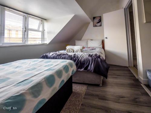 a bedroom with a bed with two stuffed animals on it at En-suite 6 Woodhouse, private bath, 2 kitchen in Stoke on Trent