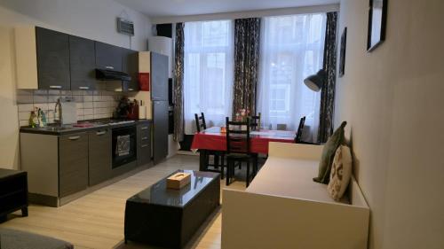 a kitchen and living room with a couch and a table at Royal sleeping Brussels in Brussels